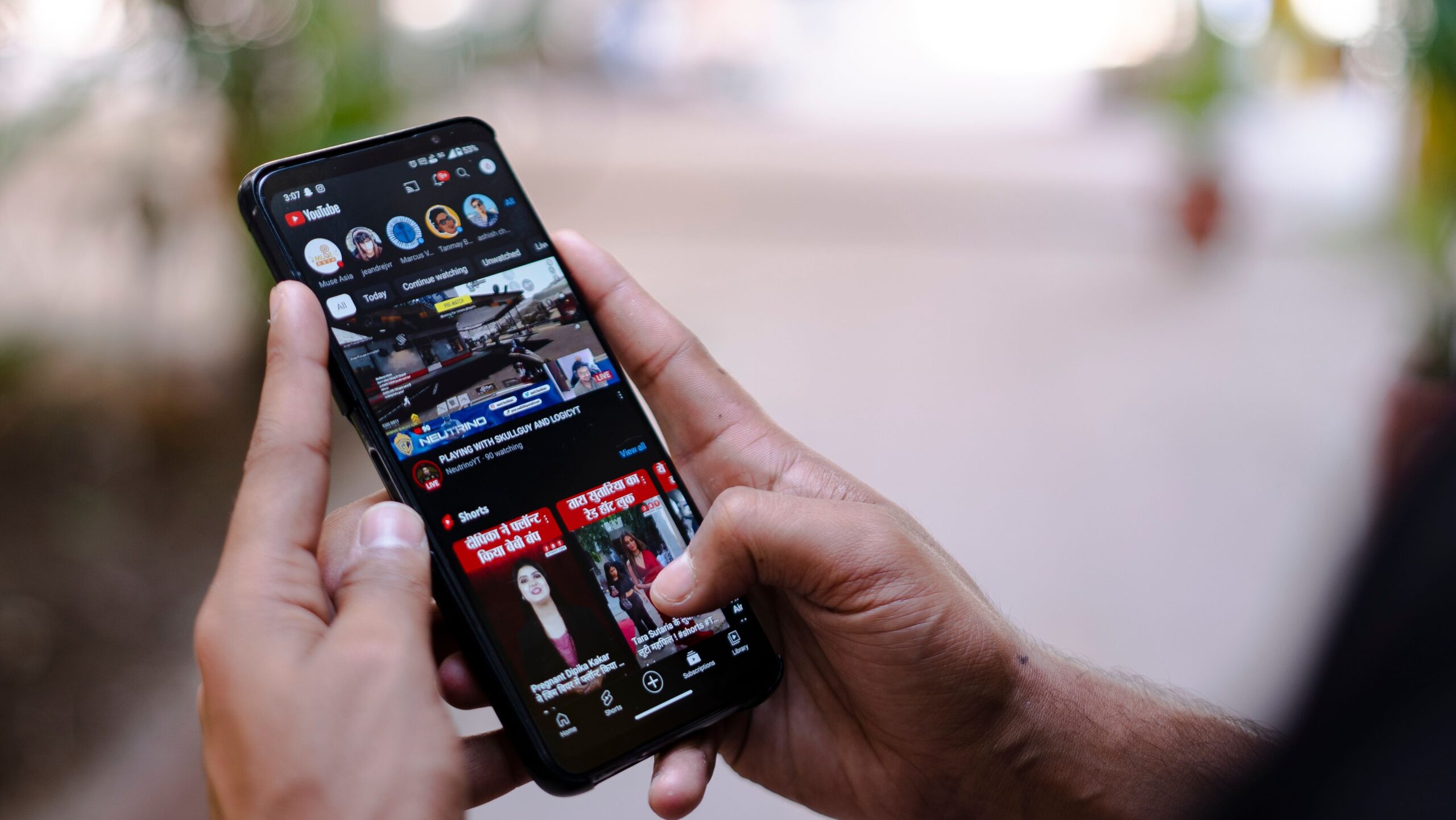 Reddit SEO Singapore Field Report After Google's May 2026 Core Update 3 Man holding phone scrolling YouTube organic search results after Google May 2026 Core Update